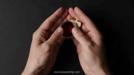Manos adultas fondo negro profundo sosteniendo copa pequena cristal vino tinto pan pasas encima plano cenital intimo poderoso dramatico devocional santa cena oscuridad luz